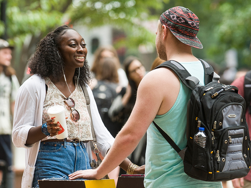 Students talking at VCU sign